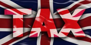 Tax wording against Union Jack flag background