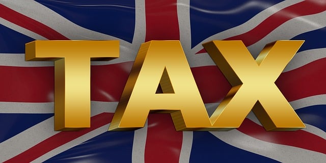 the word tax with a UK flag background