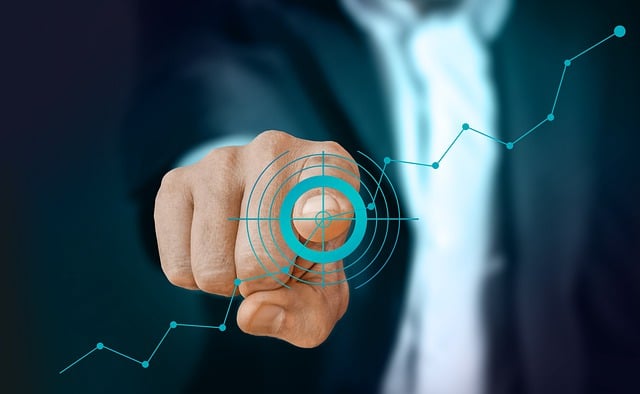 Business man pointing to point on a graph
