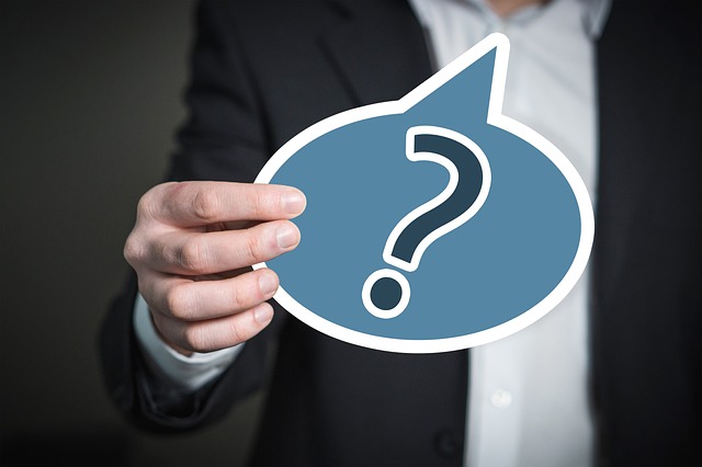 Person holding a question mark sign