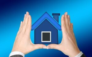 hands surrounding house