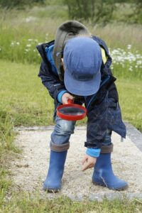 Boy looking through magnifying glass