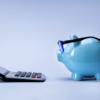 piggy bank looking at accounting com puter